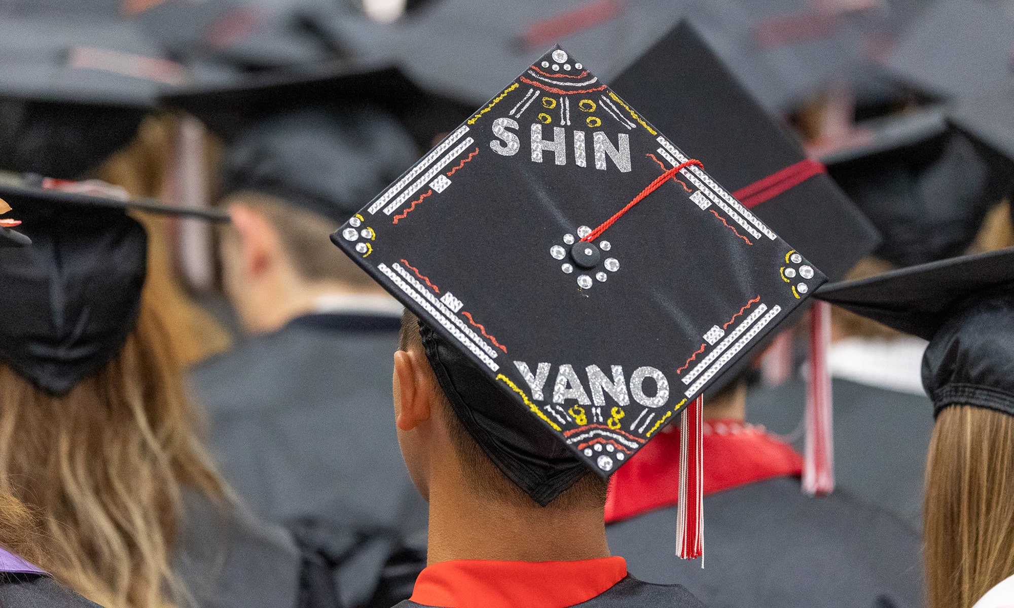 Student graduation cap decorated that reads 'Shin Yano'