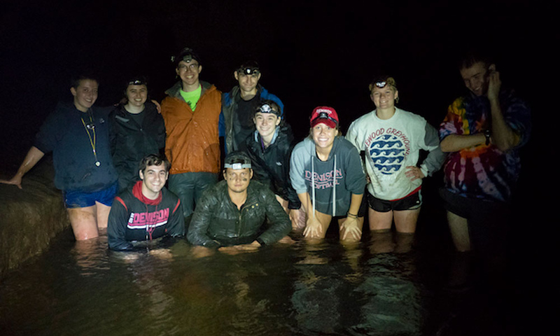 Group photo of students in dark cave