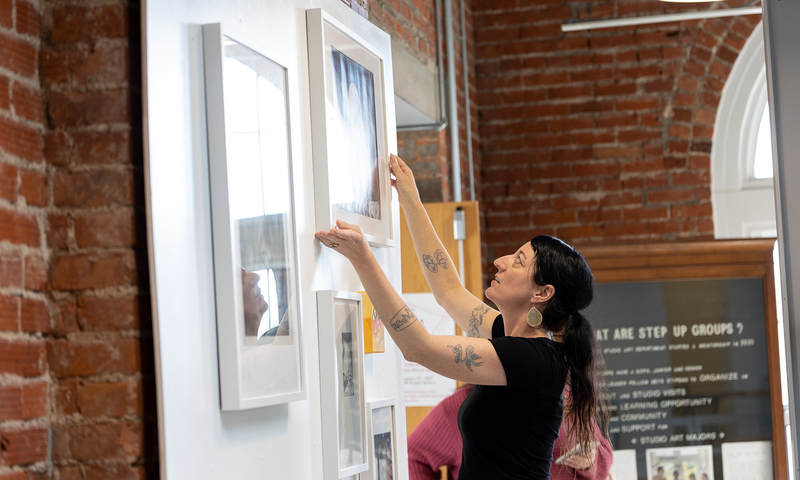 Associate professor Sheilah ReStack (center, taking photograph) says the Studio Art Lending Library was started to get student artworks out of the Bryant Arts Center and into buildings across campus.