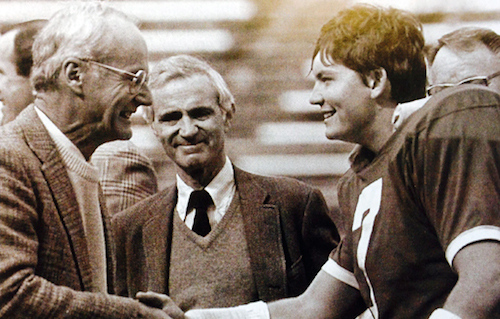 In the fall of 1987 on Deeds Field, senior Grant Jones '88 shakes hands with ز,Ȳַ
#########  Board Chair Chuck Brickman ''54 as University President Andrew DeRocco looks on.