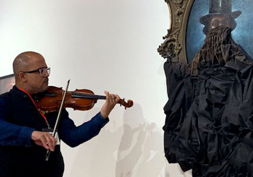 Daniel Roumain playing in concert with Titus Kaphar's A Disturbing Silence