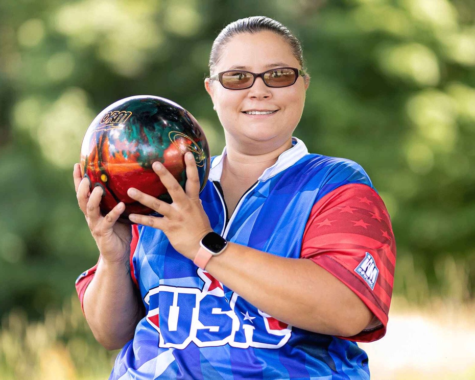 Jerrica in her bowling uniform holding a bowling ball