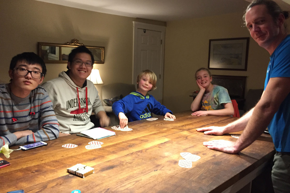 Henshaw family and students playing board game