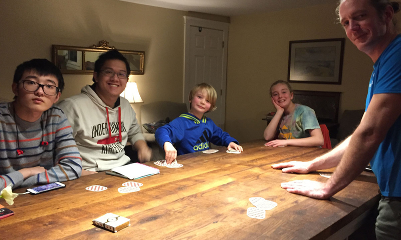 Henshaw family and students playing board game